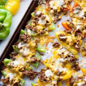 keto melted nacho cheese on top of ground beef and bell peppers on baking sheet