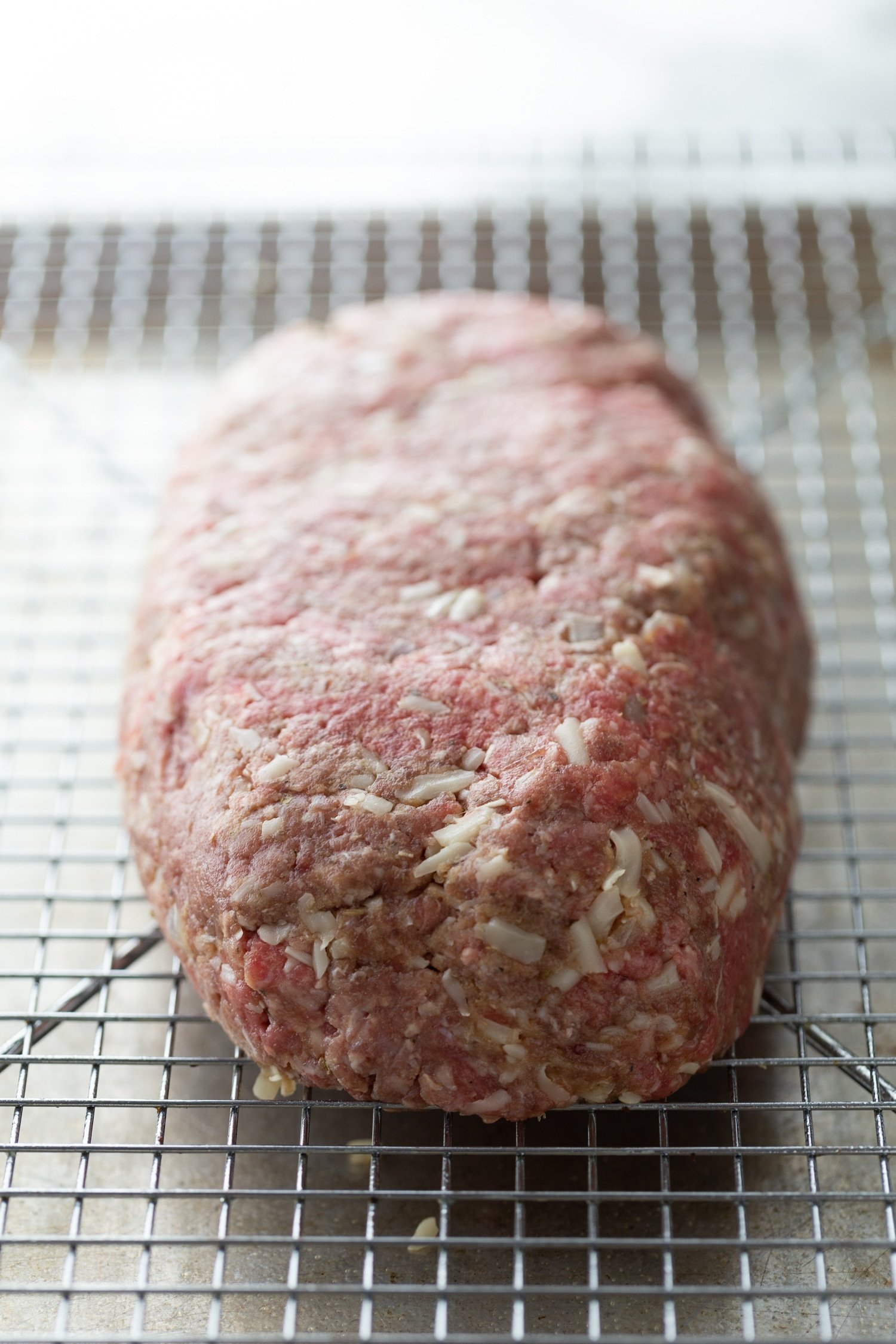 meat mixture shaped into a loaf on baking rack