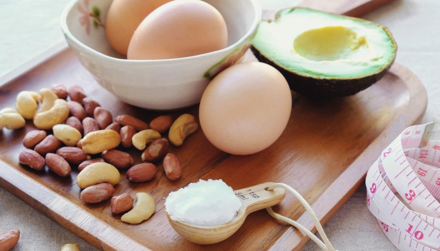 eggs, avocado, nuts and salt on a cutting board