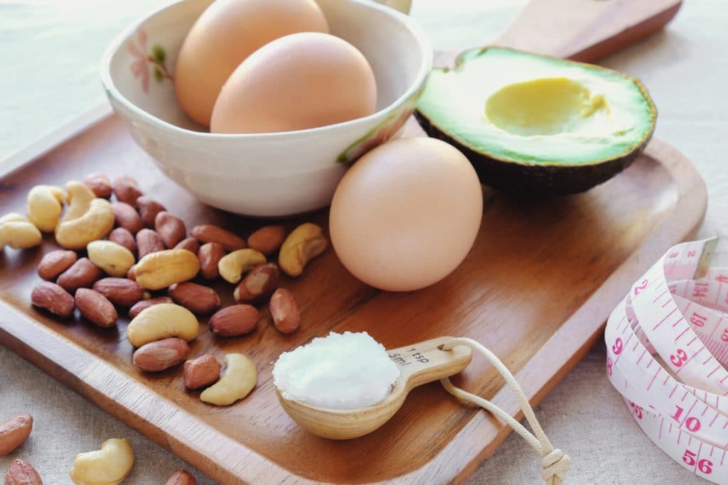 eggs, avocado, and nuts on a cutting board