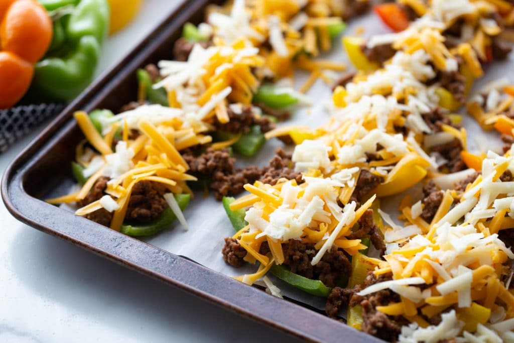 bell pepper slices stuffed with ground beef topped with shredded cheese