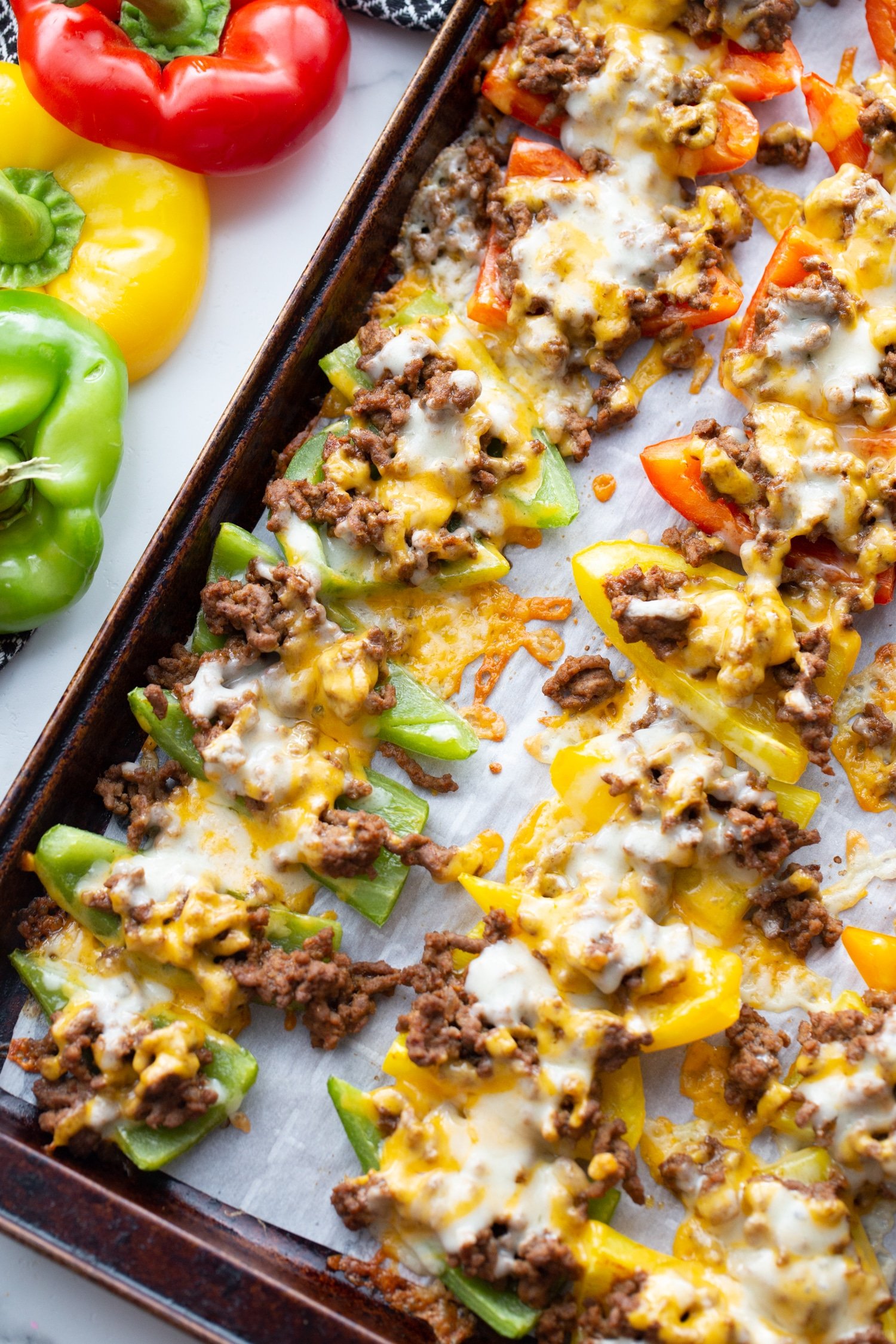 bell pepper nachos on baking sheet with melted cheese