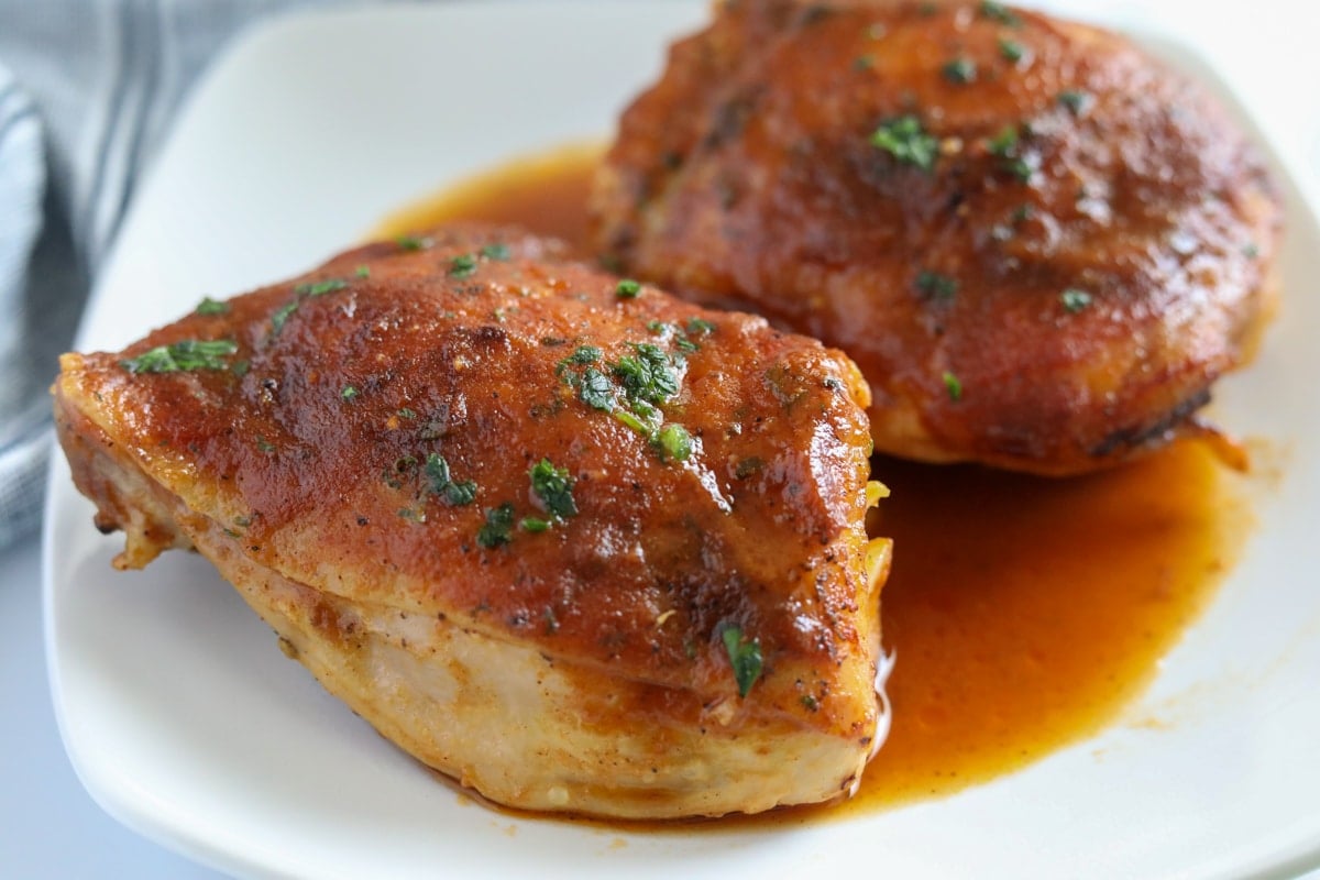 easy keto chicken thighs on a white plate with sauce