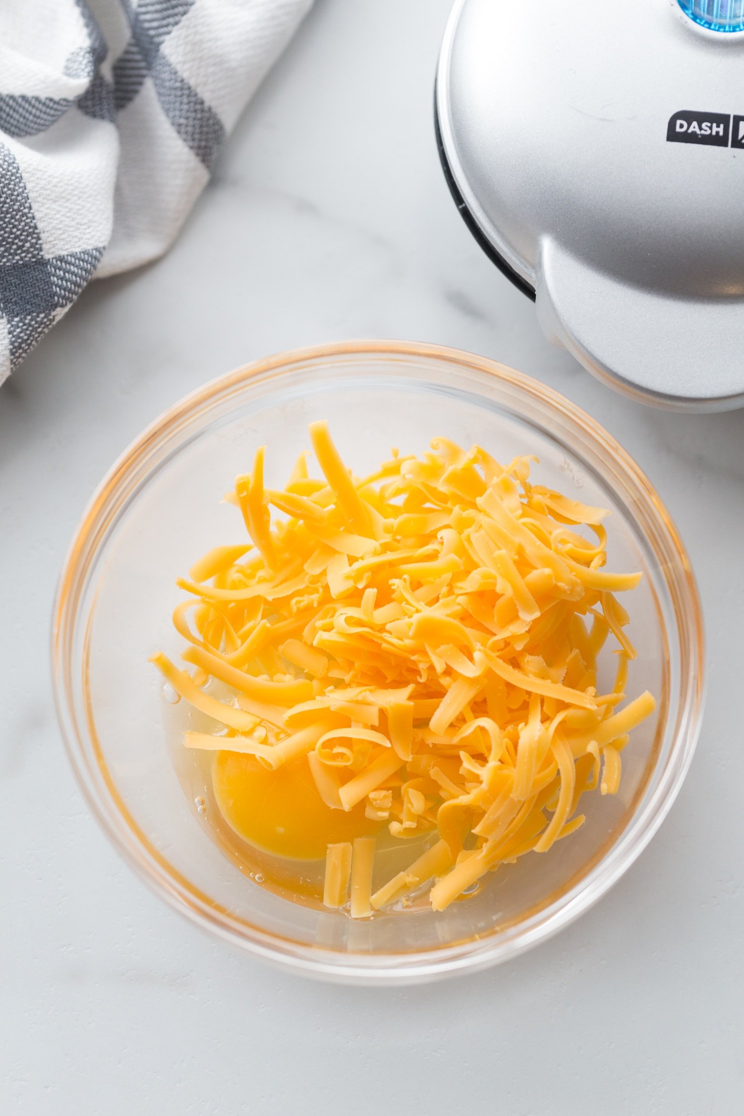 shredded cheese and egg in a bowl
