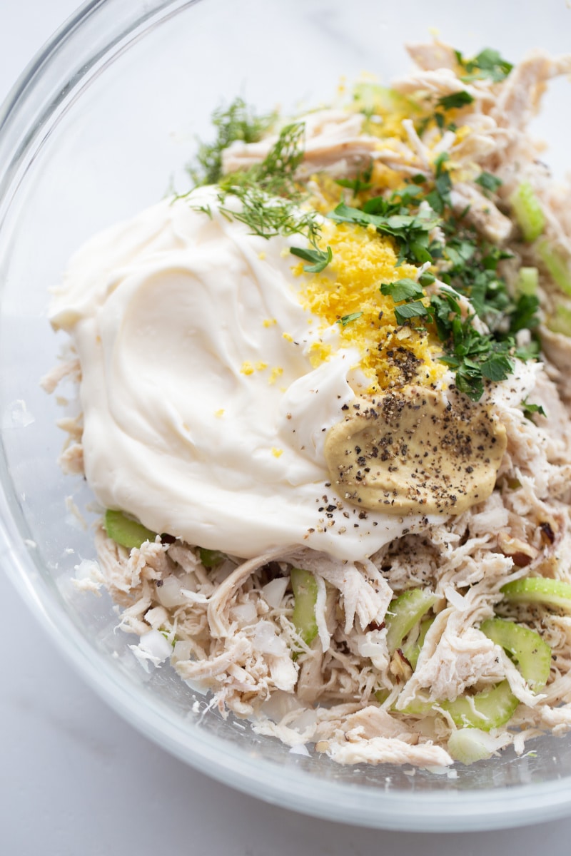 mayo, mustard, chicken, celery, onion and lemon zest in a clear bowl