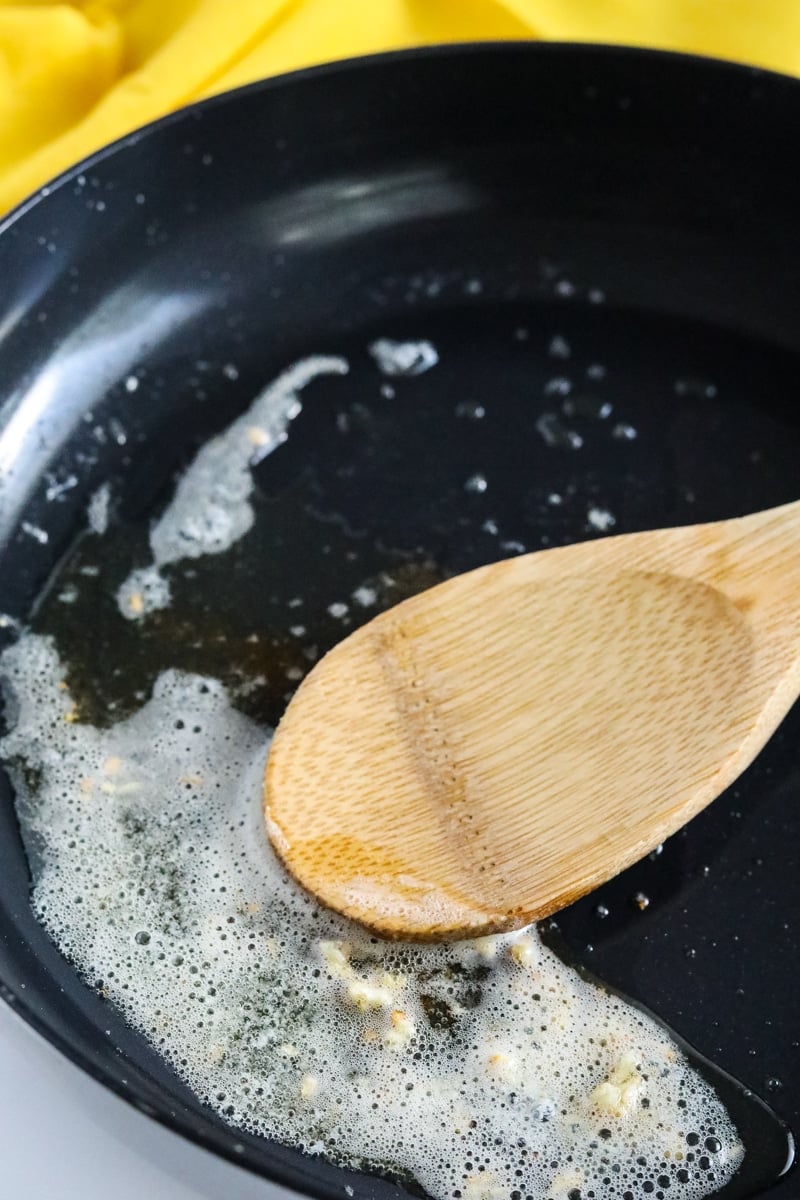 melted butter in a skillet with minced garlic.