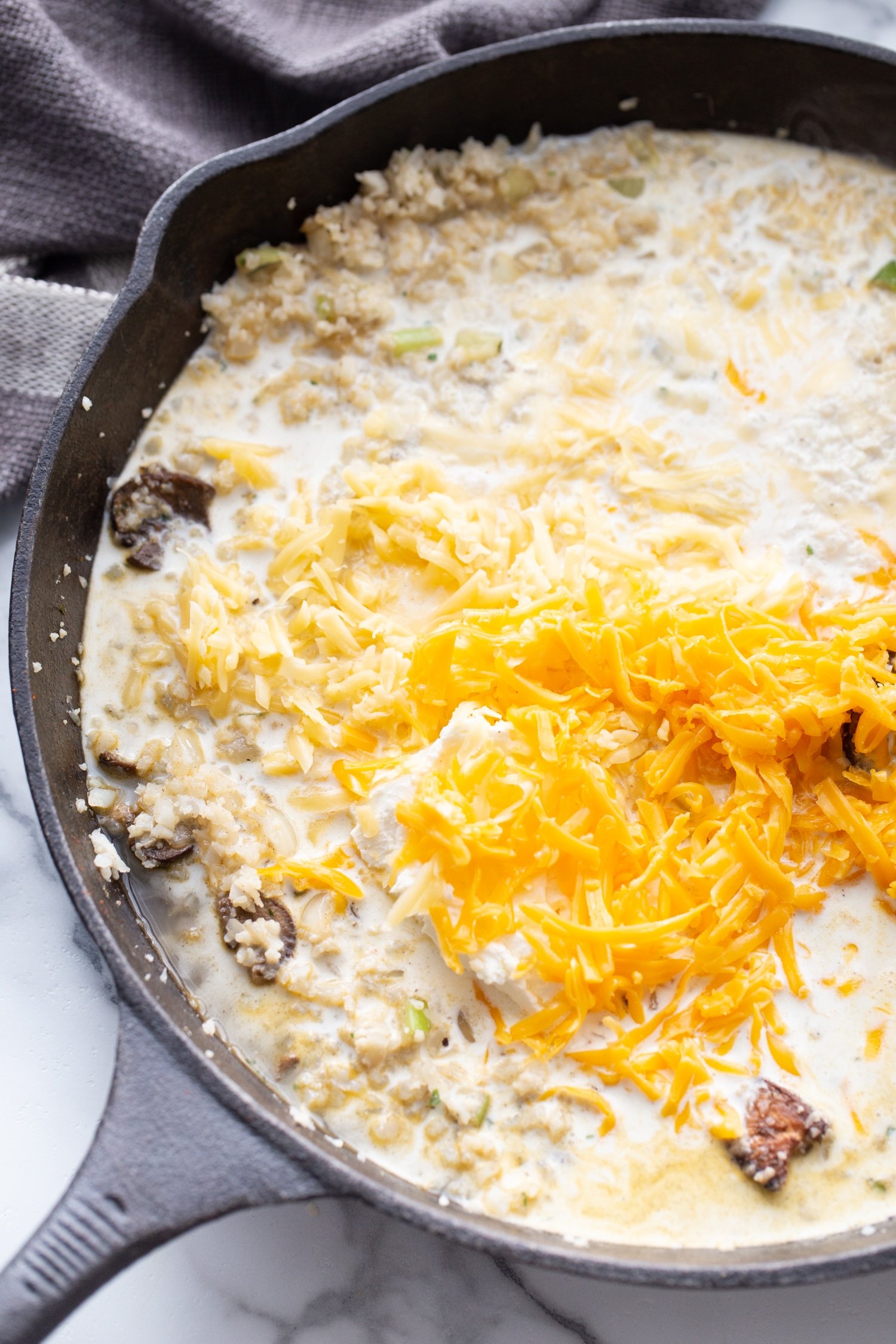 chicken rice, cheese and cream in a skillet