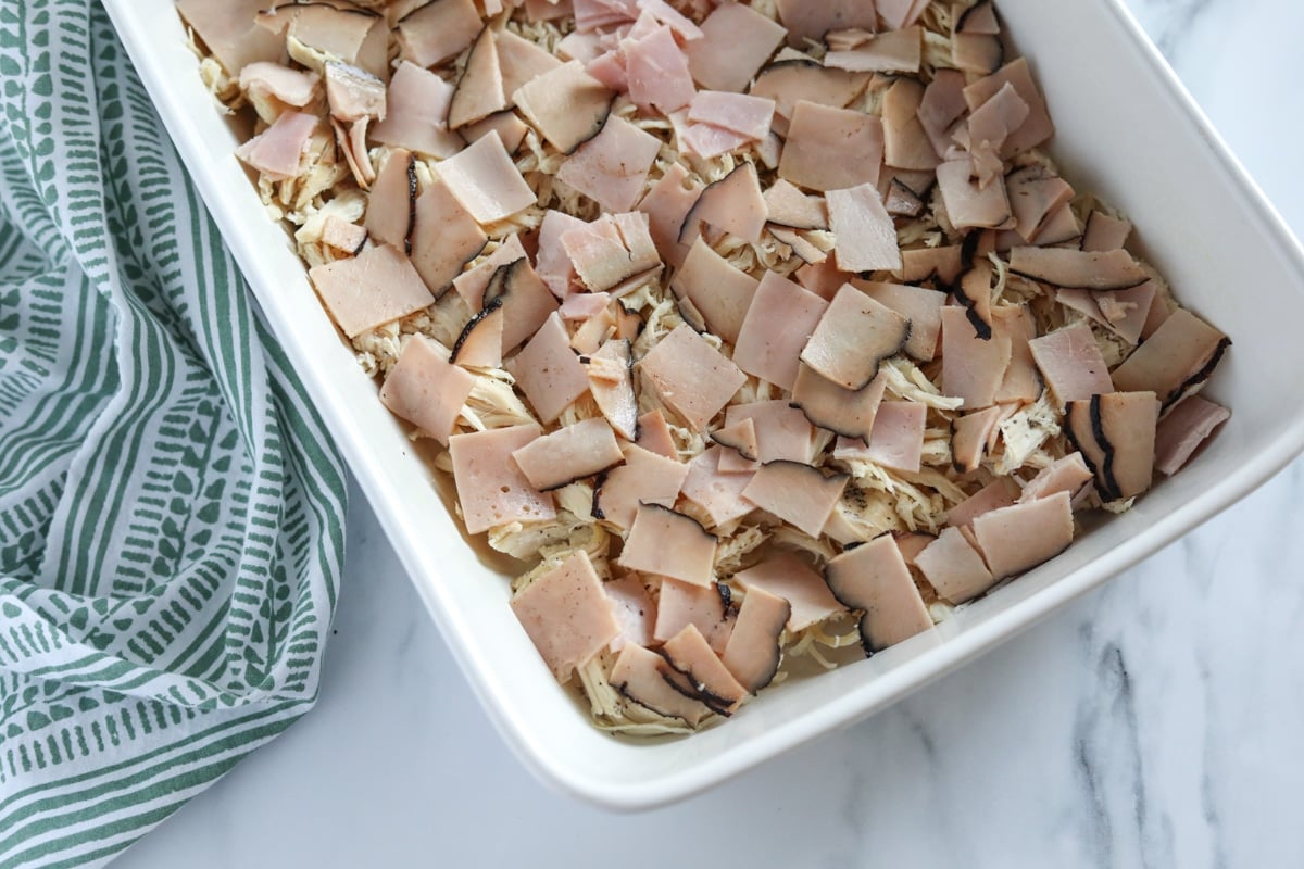shredded chicken and ham in a baking dish