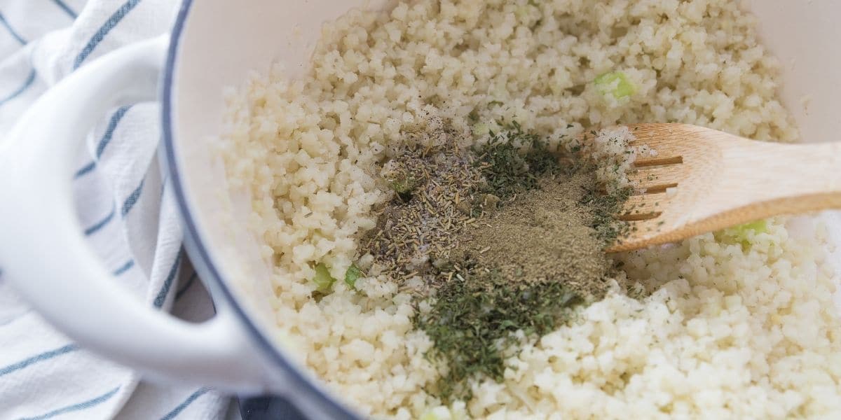 Cauliflower rice and spices in a stock pot