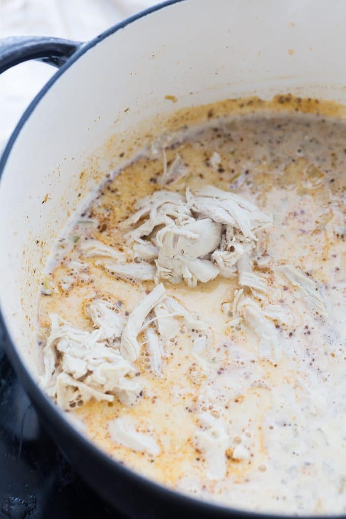 added shredded chicken to the dutch oven for keto white chicken chili