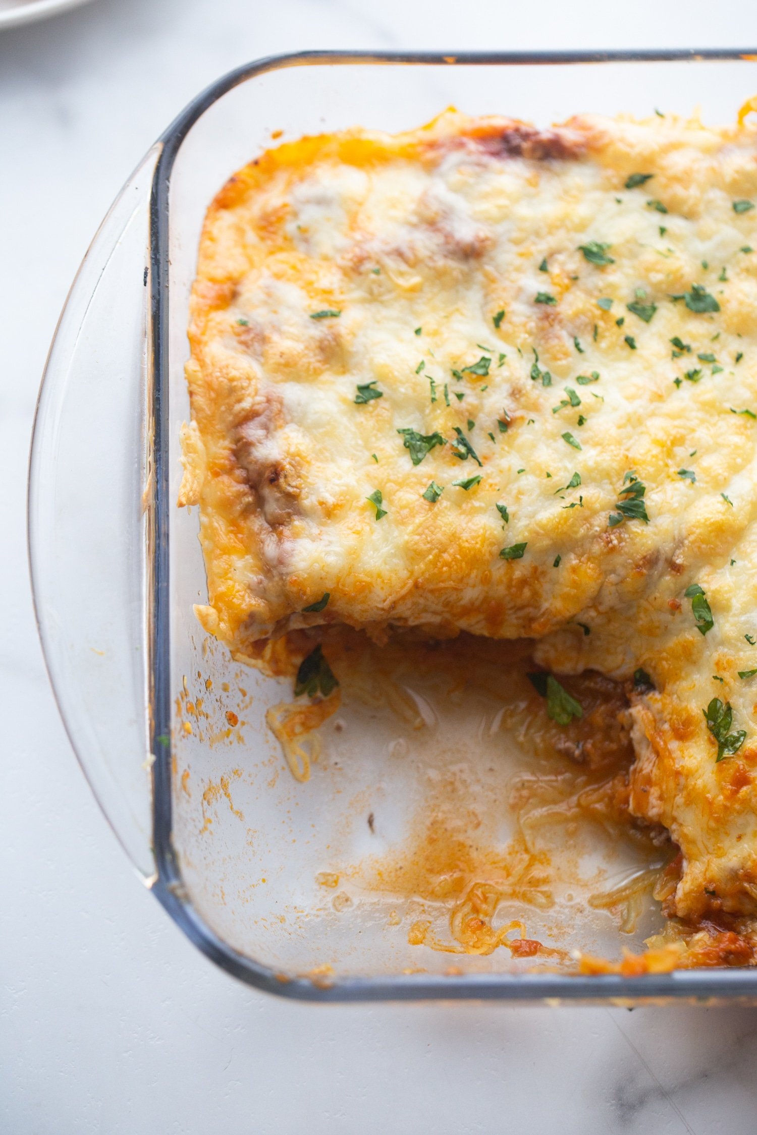 low carb baked italian casserole in a glass baking dish with a piece cut out