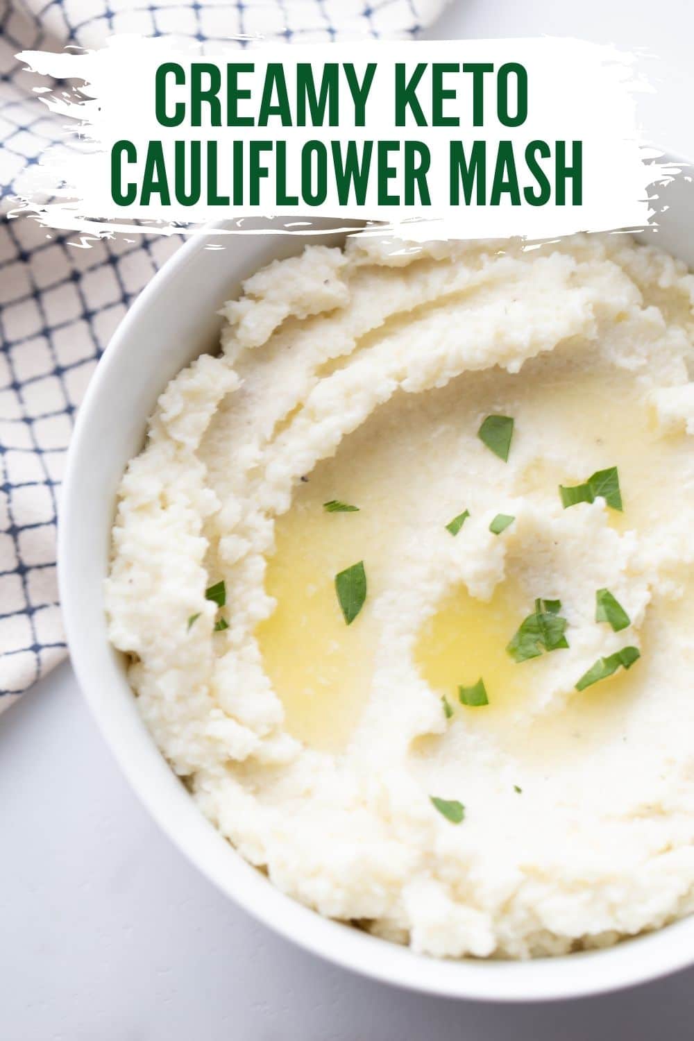 KETO CAULIFLOWER MASH IN A BOWL WITH MELTED BUTTER