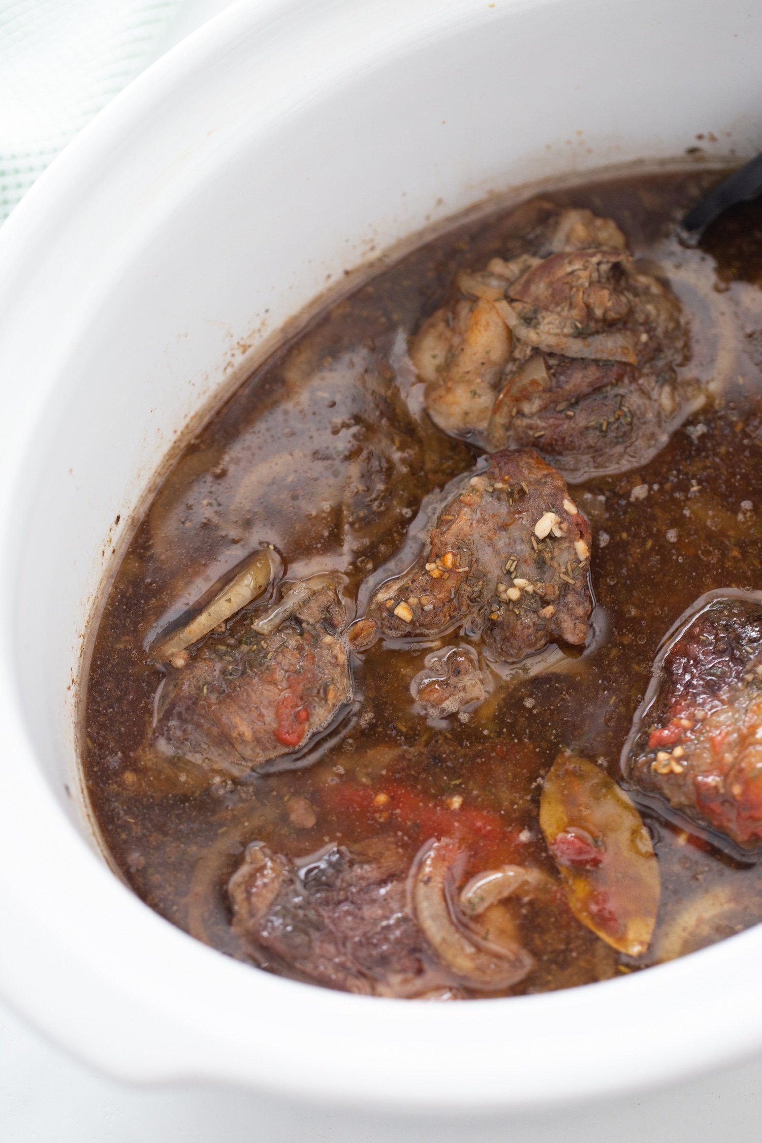 cooked keto short ribs in a sauce in the crock-pot