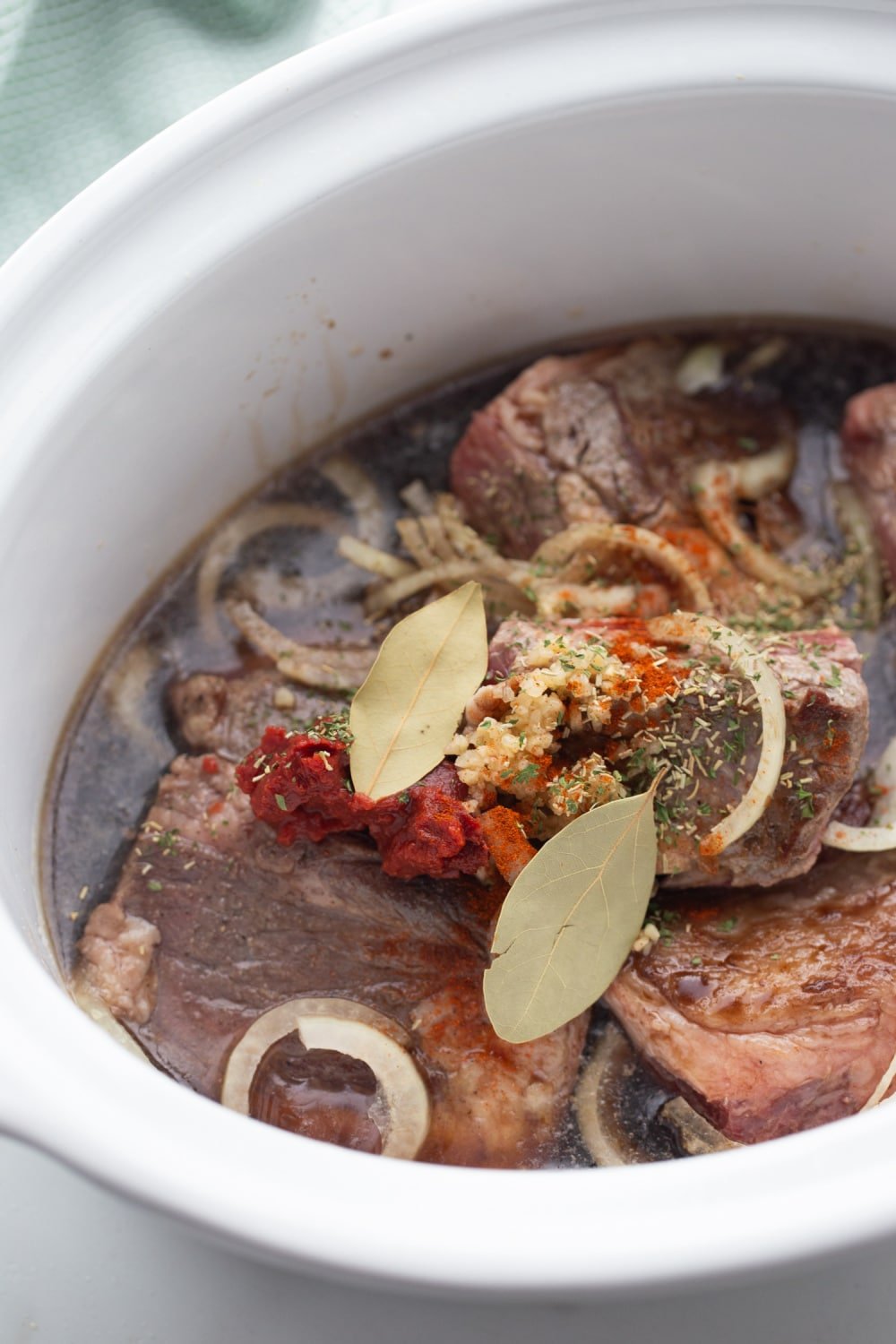 beef short ribs in the crock-pot with seasonings and beef broth