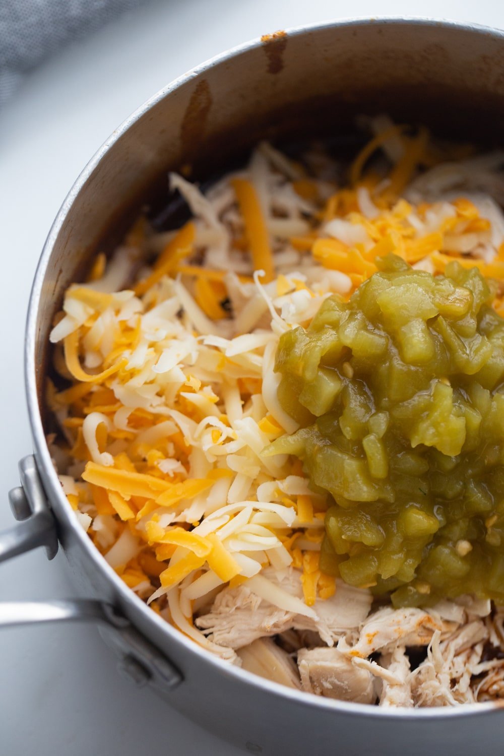 green chilies, cheese, chicken, and enchilada sauce in a skillet