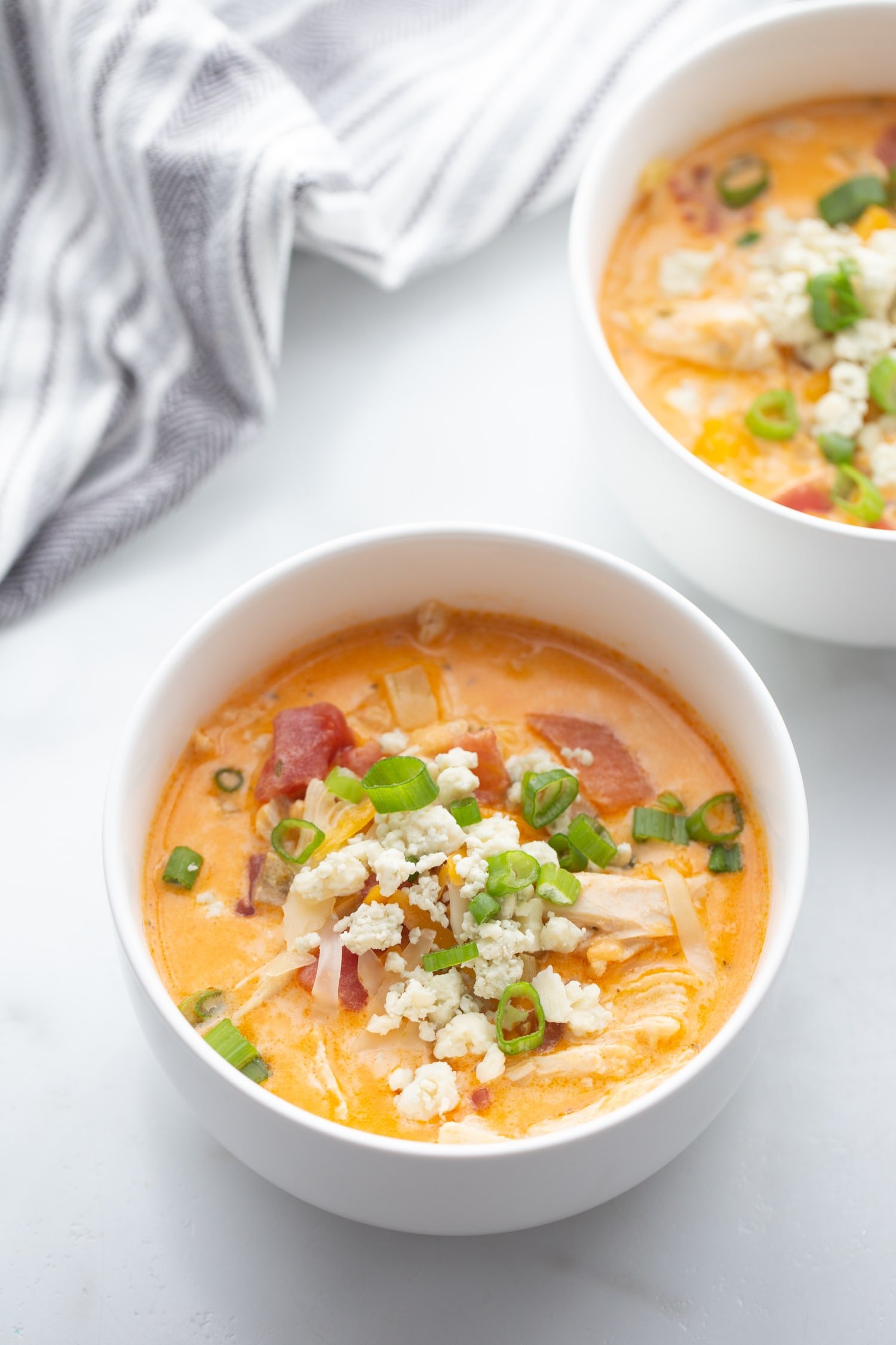 Keto Buffalo Chicken Soup in bowls garnished with blue cheese and scallions