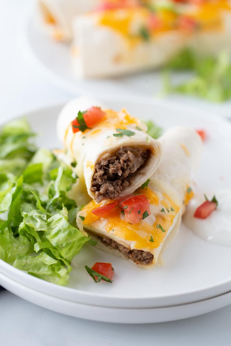 low carb burritos with ground beef stacked and on a plate 