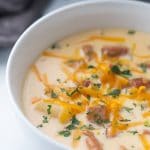 cheesy sausage low carb soup in a white bowl