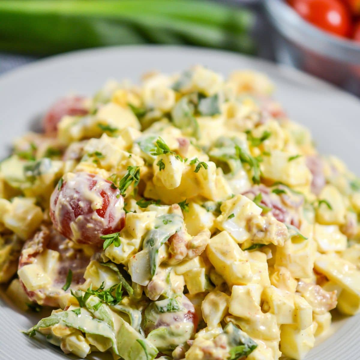 egg salad with lettuce and bacon plated