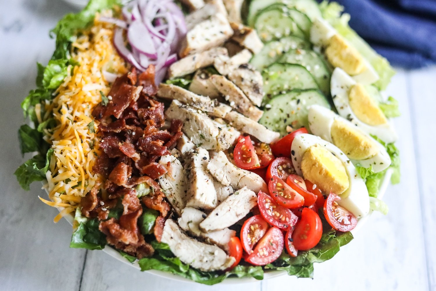 keto Cobb salad plated on white background