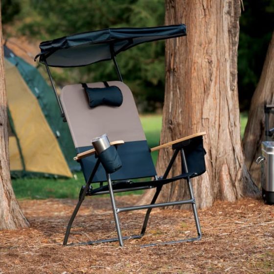 Pic of a camping chair with a tent behind it