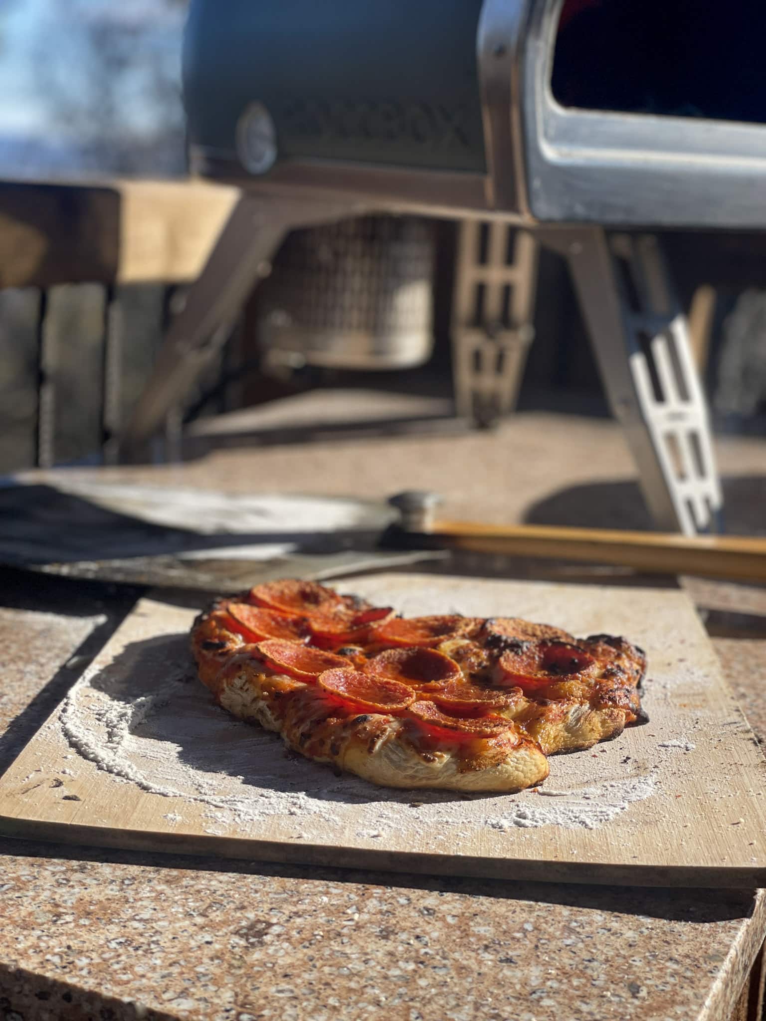 cooked pizza by pizza oven
