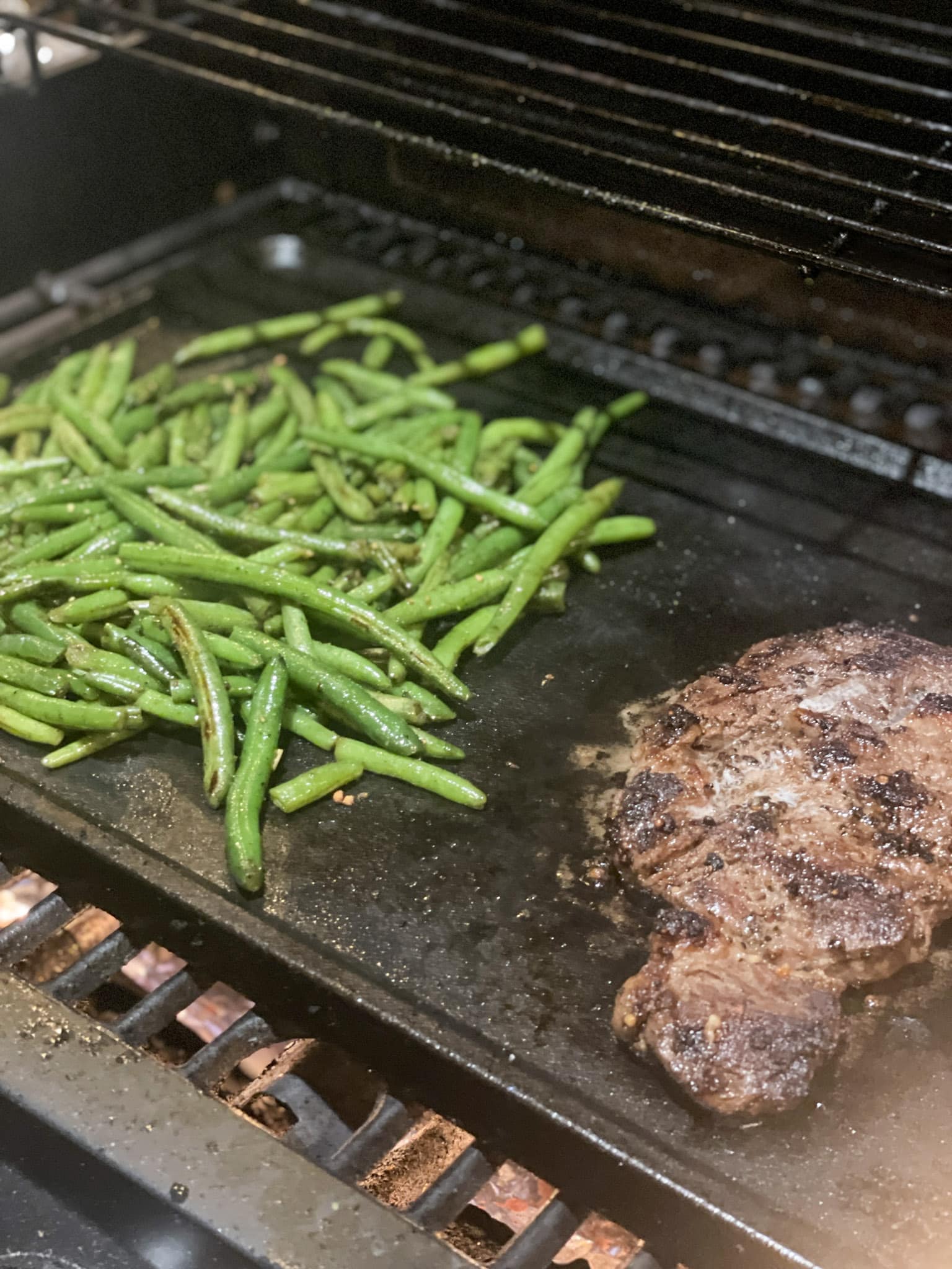 steak and green beans on grill