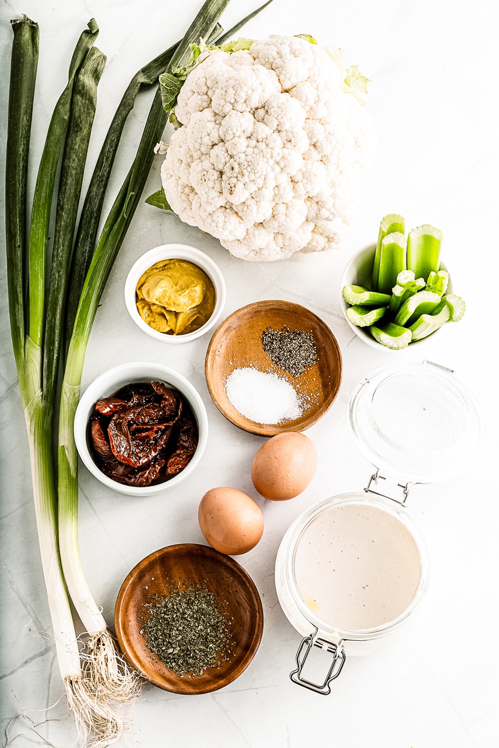 ingredients in bowls for salad with cauliflower and eggs