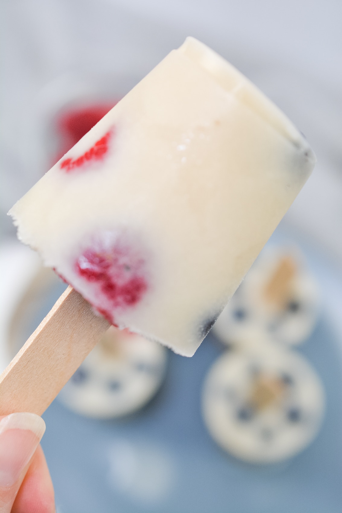 close up photo of a low-carb popsicle showing raspberries 