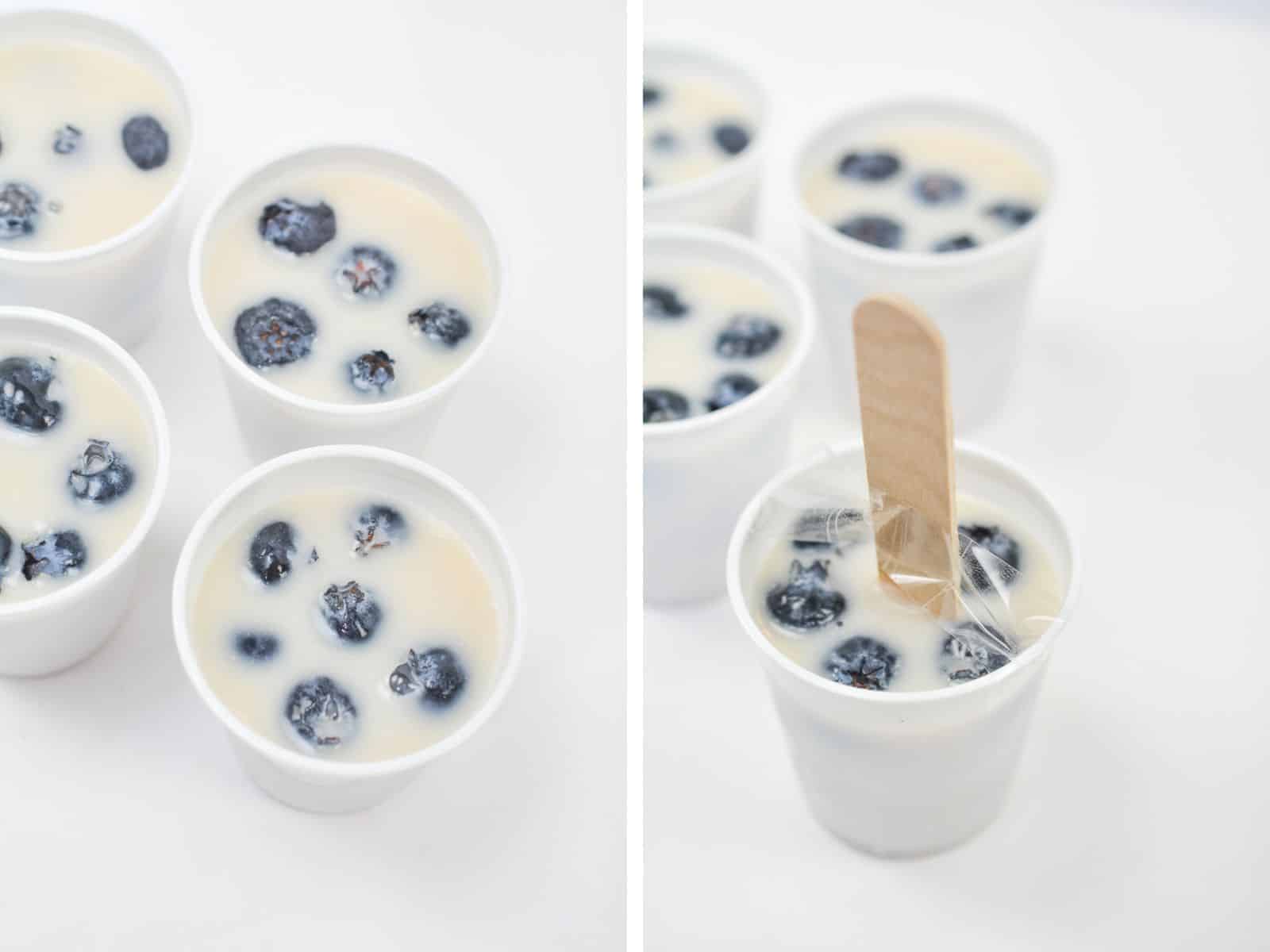 top view of keto blueberry popsicles with a stick in a small cup