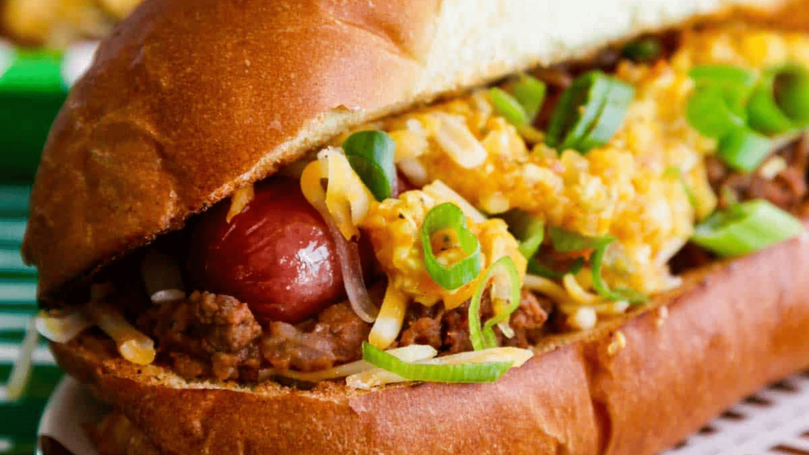Close up of hot dog in bun topped with hot dog chili
