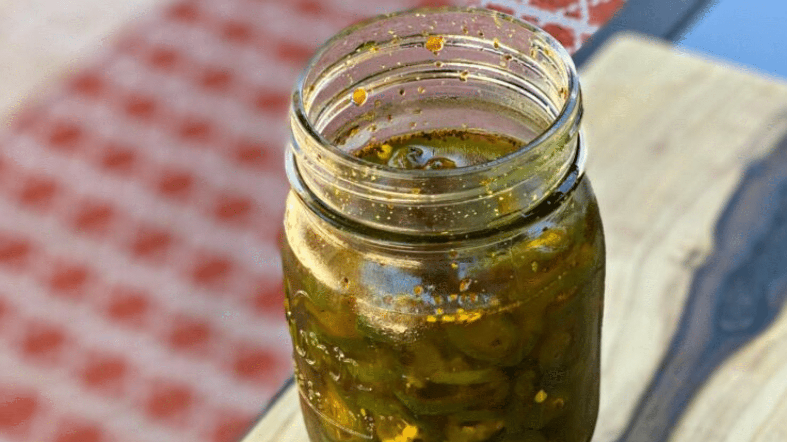 Close up of mason jar with candied jalapenos