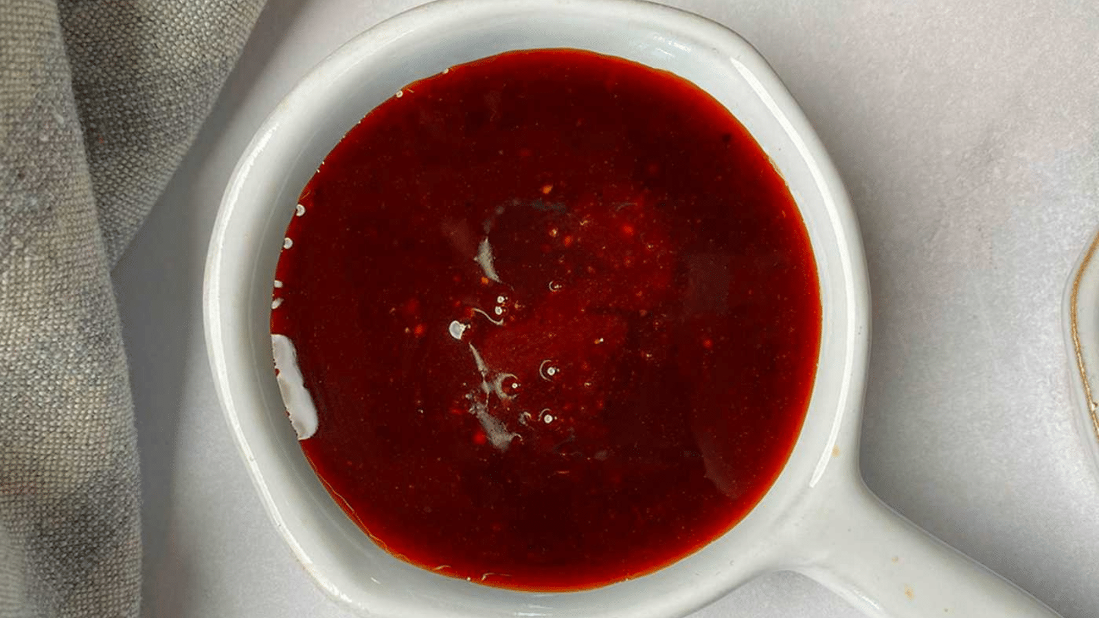 Close up of sweet heat sauce in white bowl