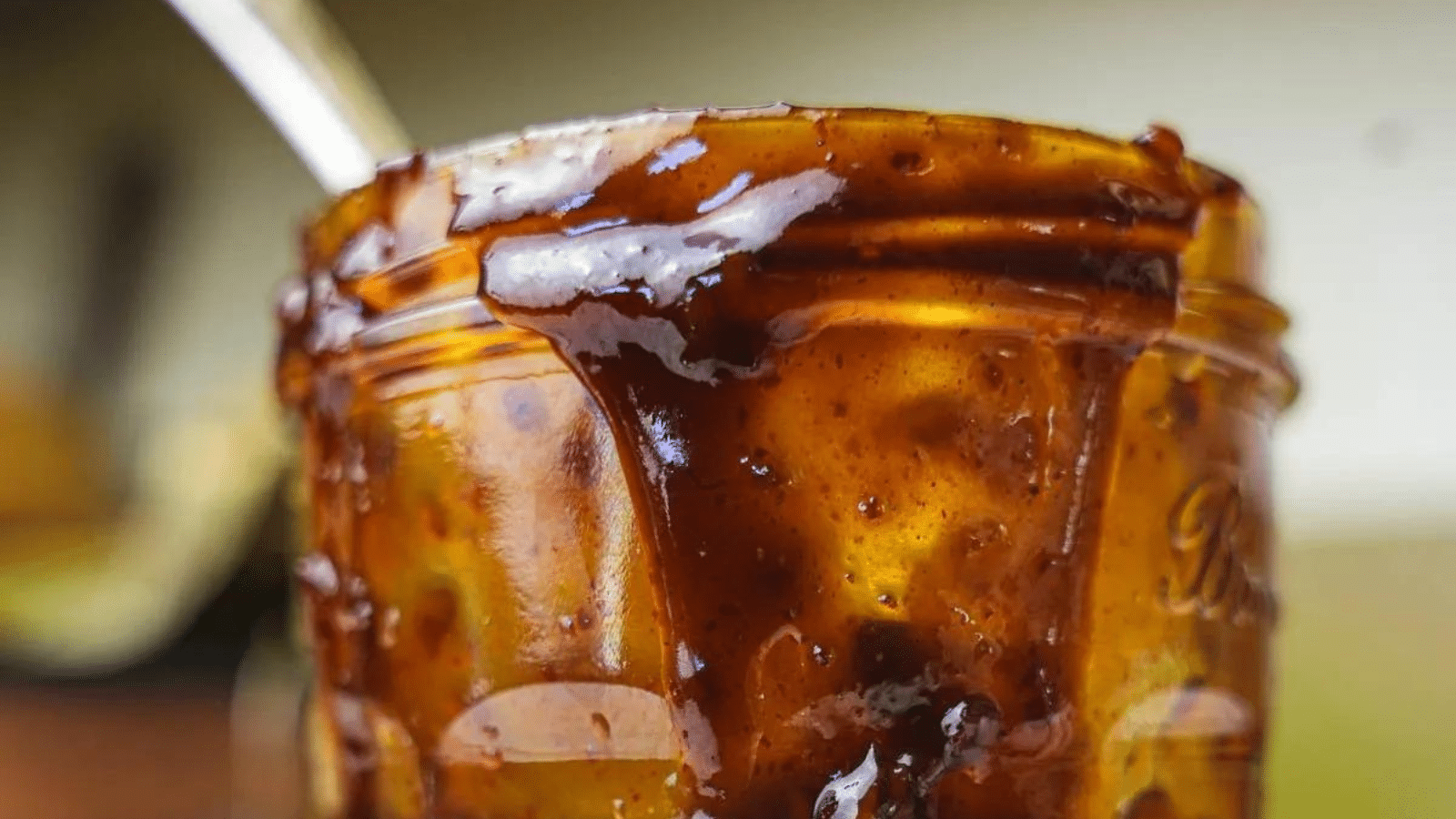 Close up of Korean BBQ sauce in jar with spoon in jar
