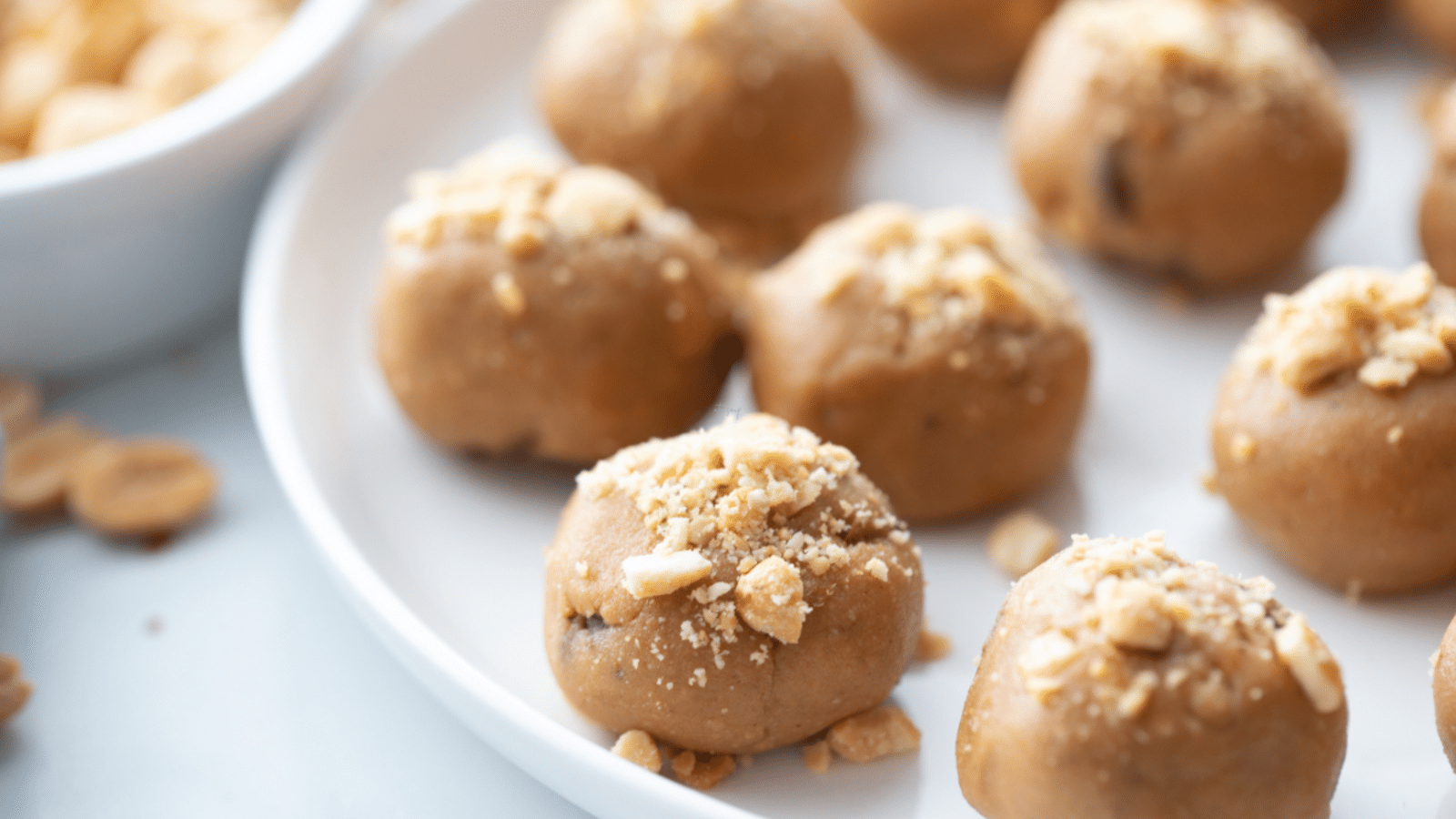 close up of peanut butter balls on white plate
