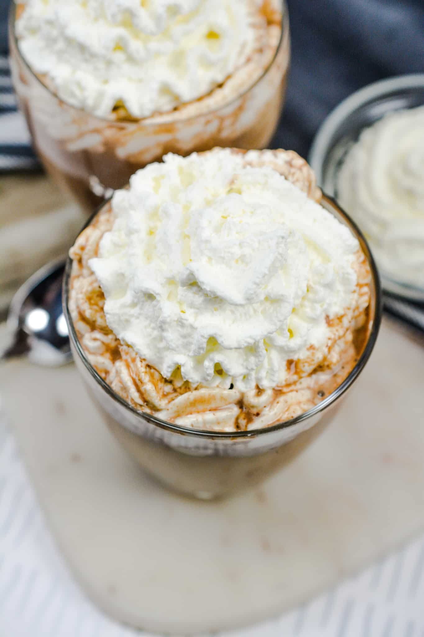 top down view of Clear glass full with diabetic friendly hot chocolate recipe and topped with whipped cream.