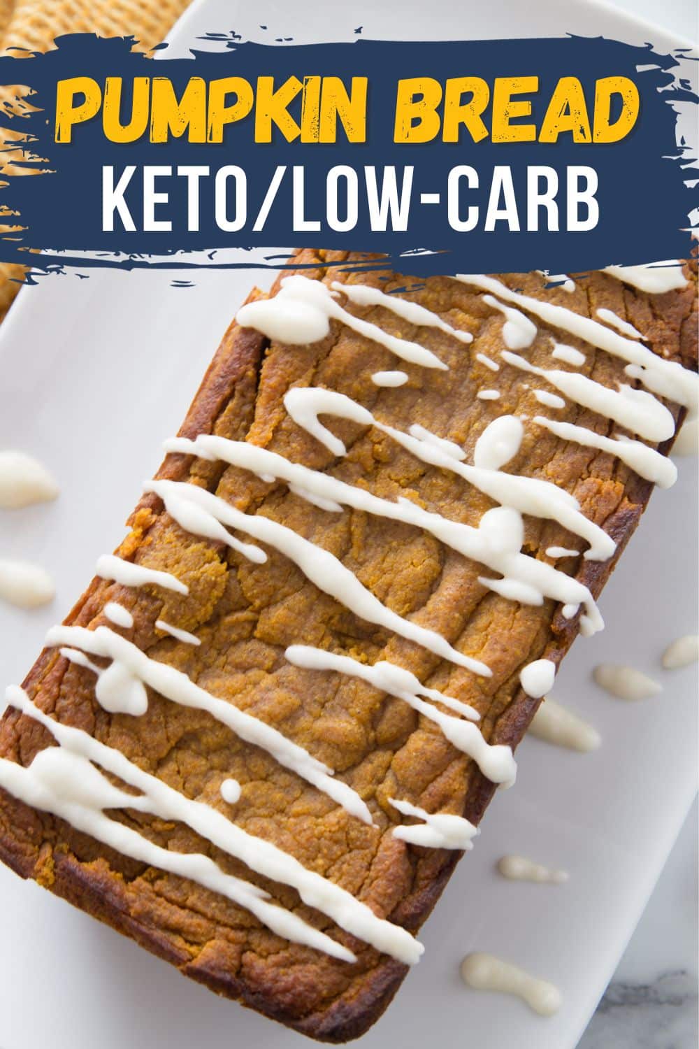 a loaf of keto pumpkin bread on a white background with glaze drizzled on top