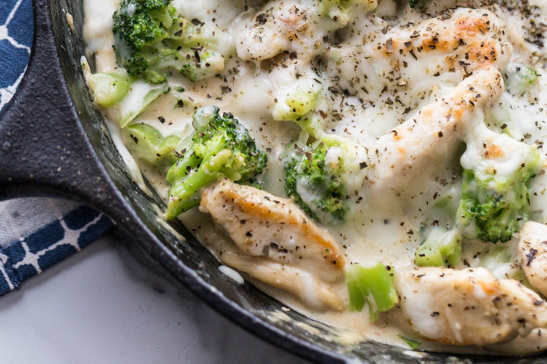 skillet with chicken, Alfredo sauce, and broccoli 