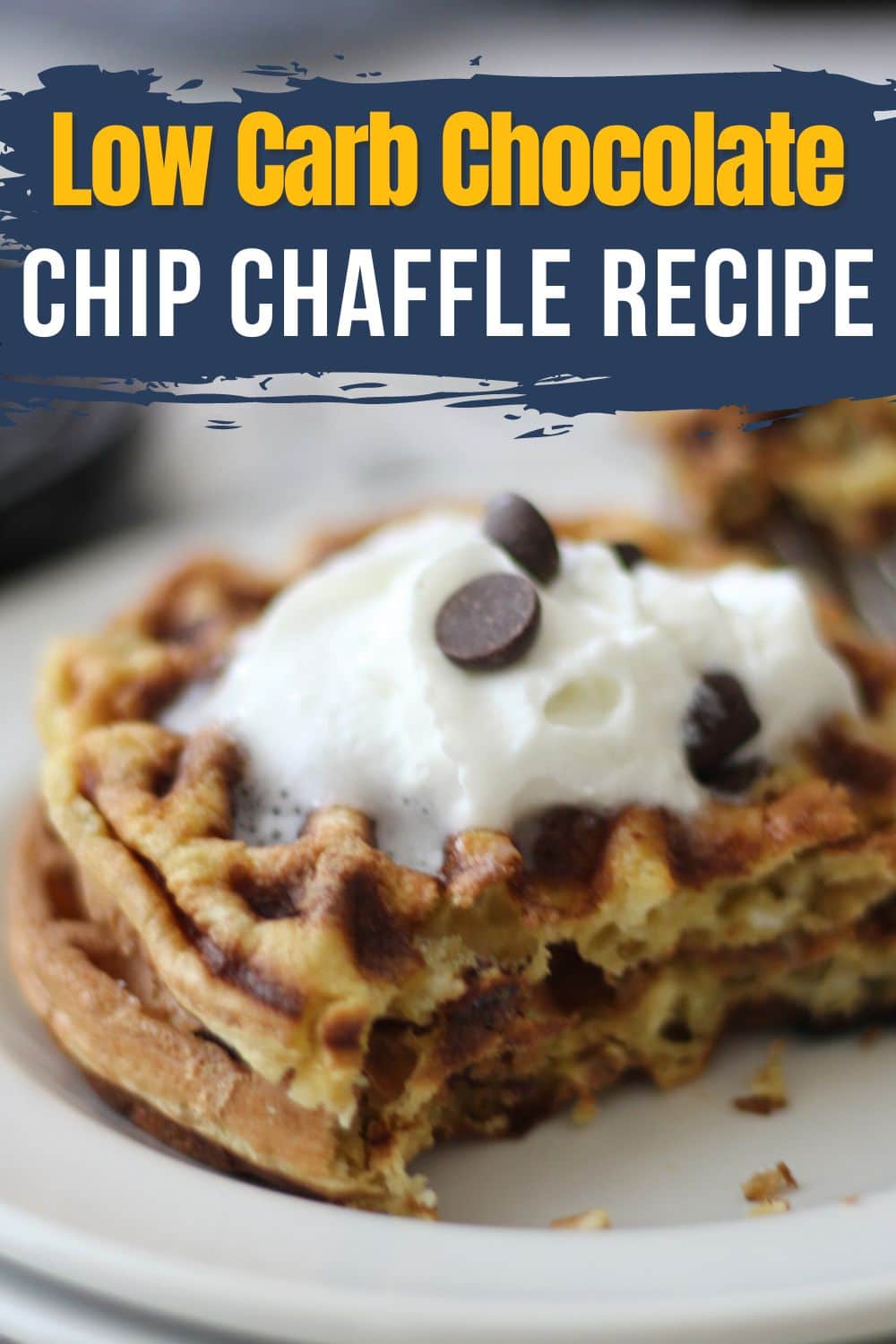 A diagonally shot stack of two chaffles topped with whipped cream and chocolate chips. Golden brown chaffles have chocolate chips baked in and are cut partway to reveal the fluffy interior. Overlaid text reads “Low Carb Chocolate Chip Chaffle Recipe”. The rich chocolate chaffles and bright toppings are attractively arranged with some depth of field. This hero image entices readers with the luscious chocolate chip chaffle recipe from the blog.