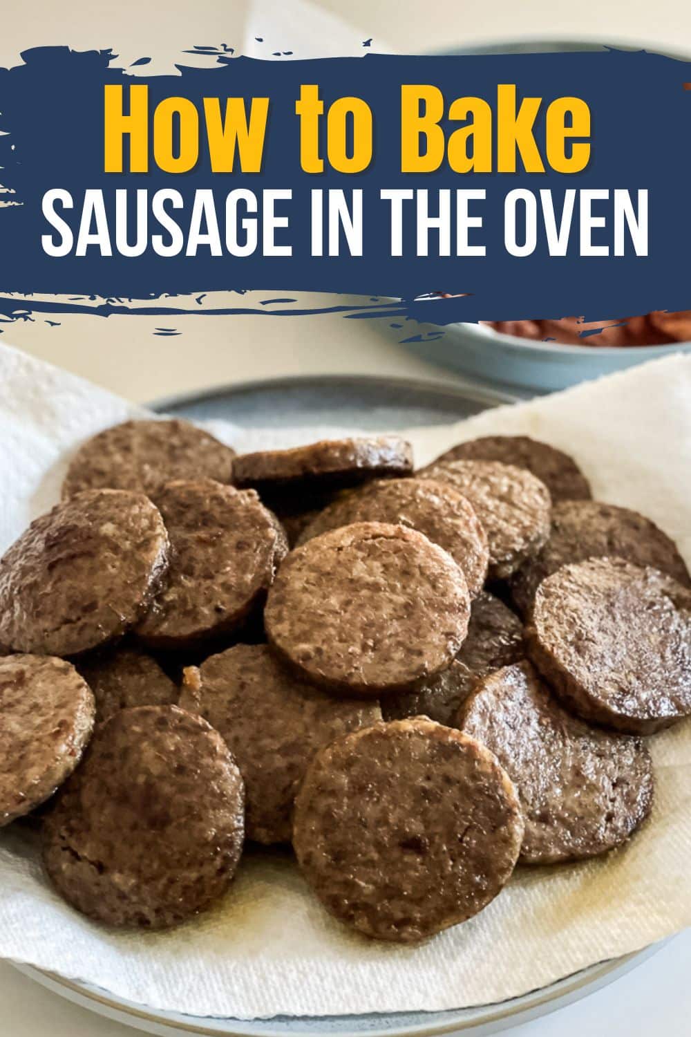Overhead view of a plate piled high with perfectly cooked sausage patties, with the text "How to Bake Sausage in the Oven" displayed on top of the image.