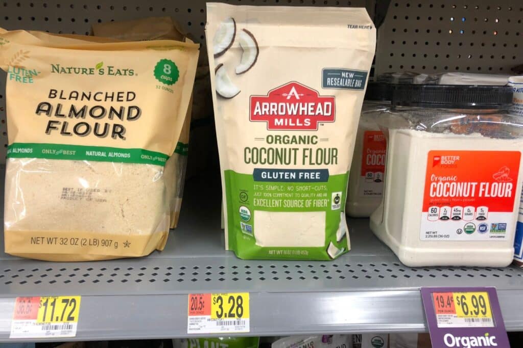 A store shelf displaying various almond flour substitutes, including coconut flour, cassava flour, all-purpose flour, and rice flour, providing options for those seeking alternatives to almond flour in their baking and cooking.