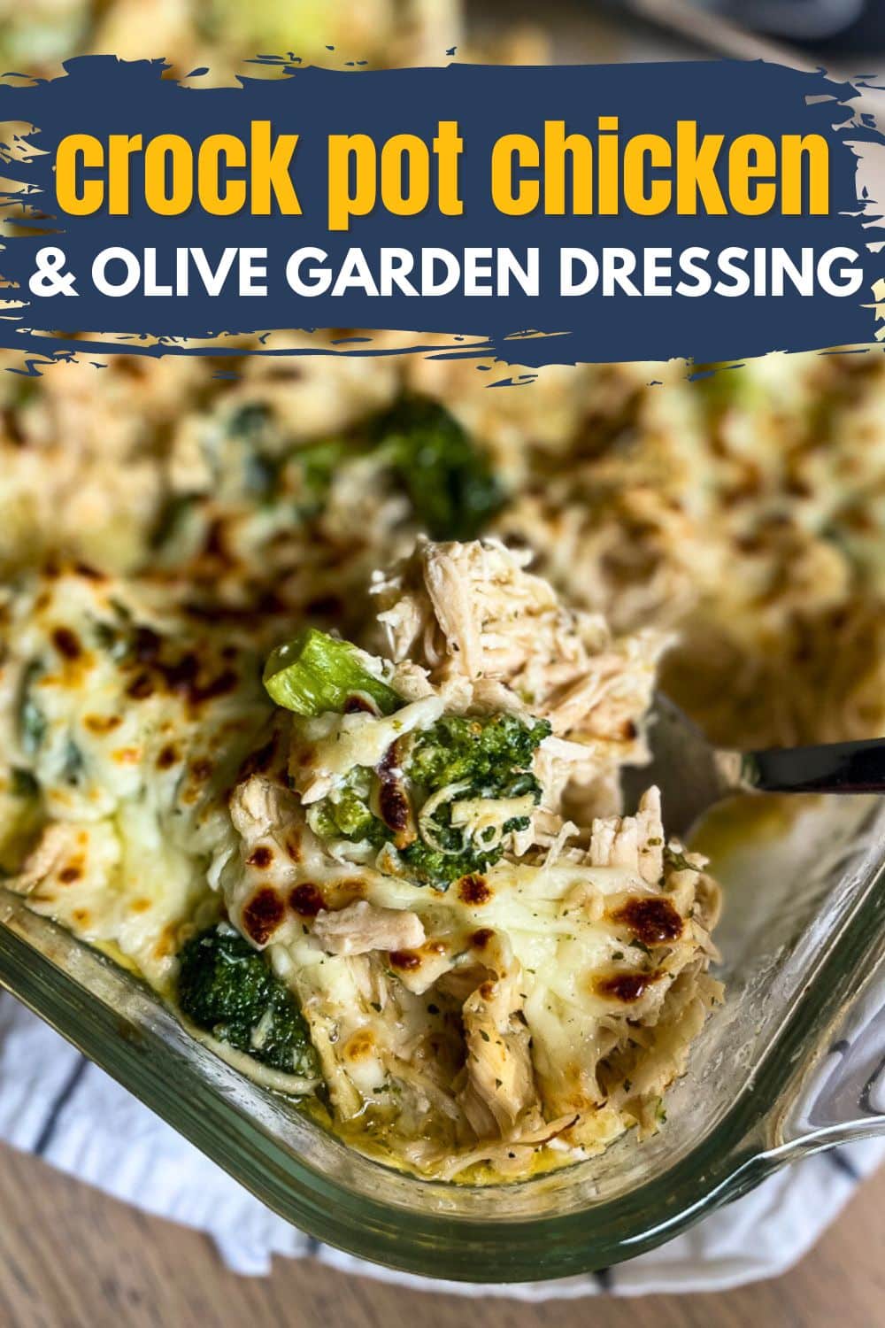 Creamy crock pot chicken with Olive Garden dressing and broccoli casserole, melted cheese topping, viral recipe in glass baking dish