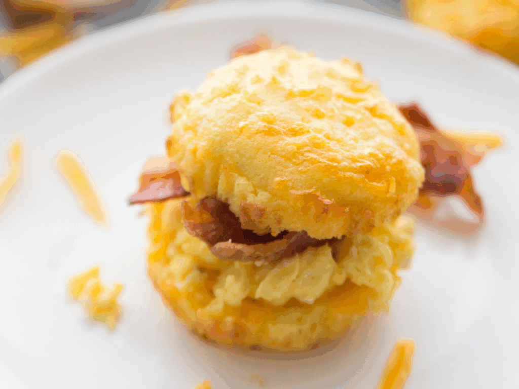 Keto Southern biscuit stuffed with bacon, egg, and cheese on a white plate