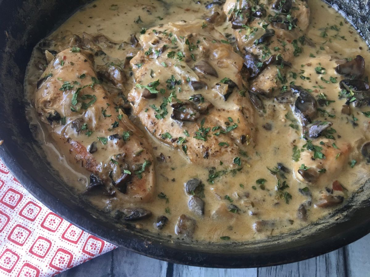 overview of creamy mushroom gravy over chicken in a skillet