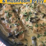 Cast iron skillet with chicken breast and mushroom sauce on top