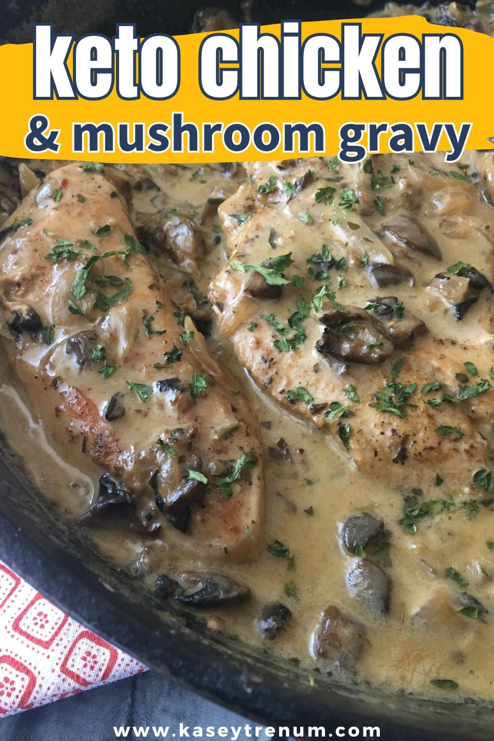 Cast iron skillet with chicken breast and mushroom sauce on top 
