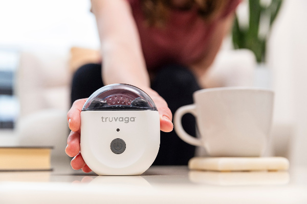 Truvaga stock image with a lady holding in her hand and a cup of coffee in the foreground