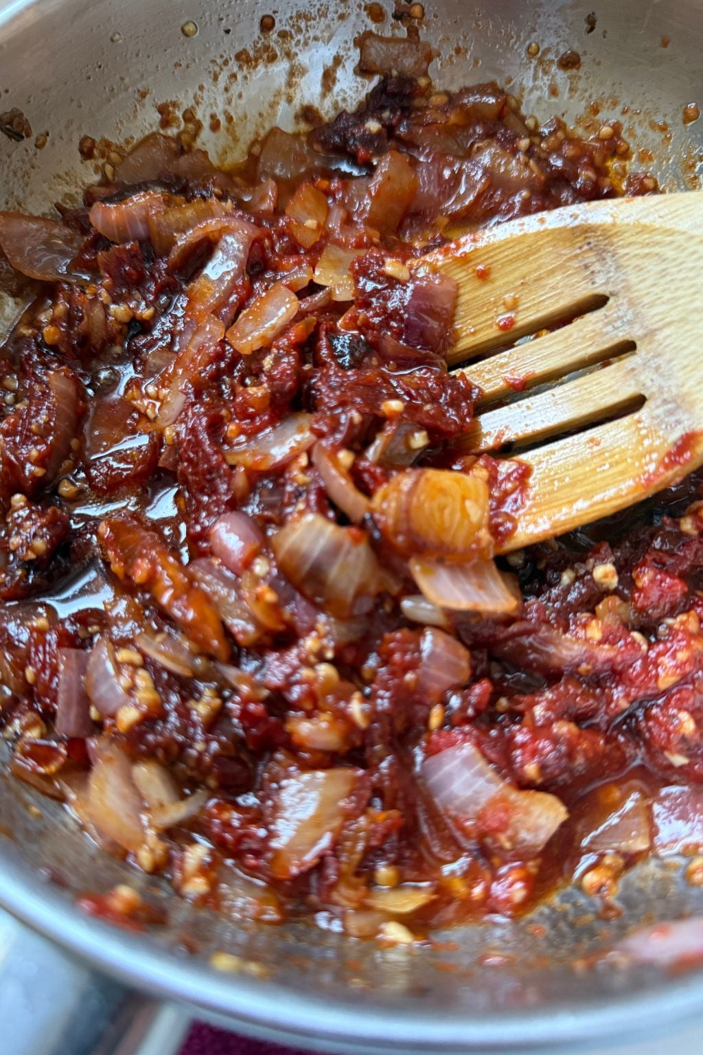Sun-dried tomatoes, onions, and garlic sautéed in a skillet to build flavor for soup