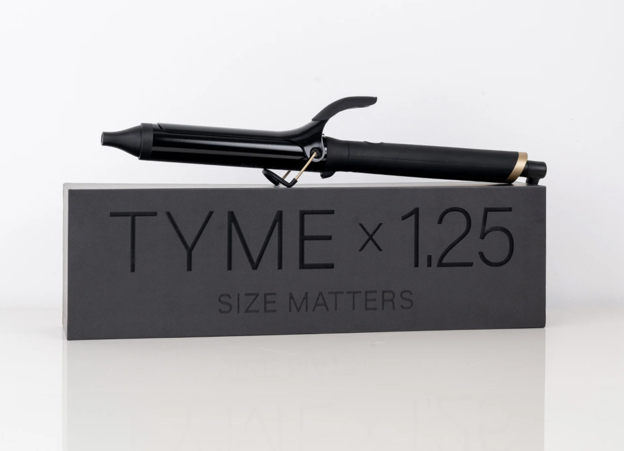 TYME 1.25 curling iron stock image with the box curilng iron on top and a white background